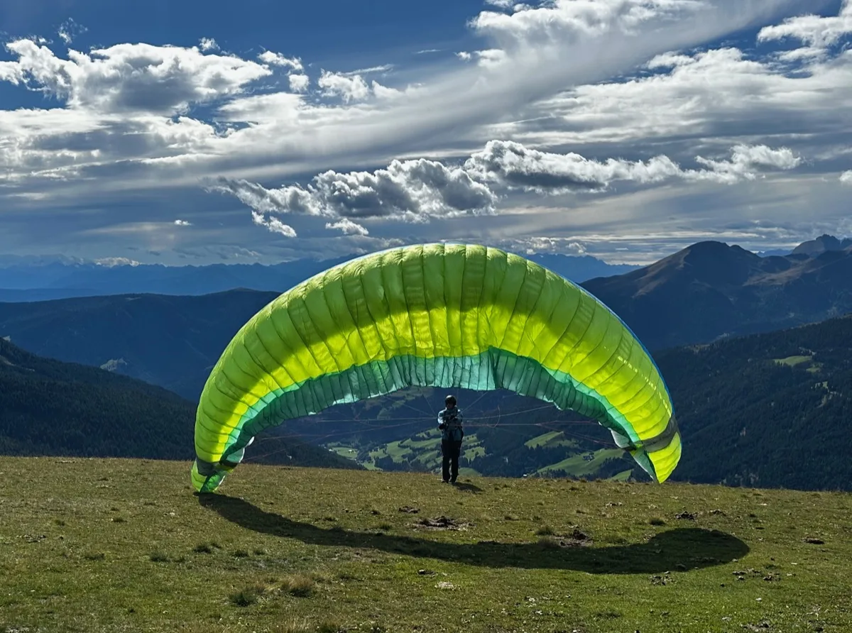 Christian launching his paraglider in the Dolomites